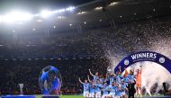 Manchester City's players lift the European Cup trophy as they celebrate on the podium after winning the UEFA Champions League final football match between Inter Milan and Manchester City at the Ataturk Olympic Stadium in Istanbul, on June 10, 2023. (Photo by Marco Bertorello / AFP)