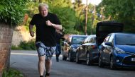 Former British Prime Minister Boris Johnson leaves his house for a run in Brightwell-cum-Stowell, west of London on June 14 2023. (Photo by Justin Tallis / AFP)