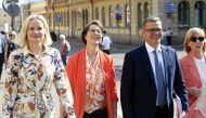 The Finns Party chair Riikka Purra (left), Christian Democrats chair Sari Essayah, National Coalition Party chair PM-designate Petteri Orpo and Swedish People's Party chair Anna-Maja Henriksson arrive to a press conference on details of the governing agenda regarding of the four-party cabinet in Helsinki, Finland, on June 16, 2023. (Photo by Kimmo Penttinen / Lehtikuva / AFP)