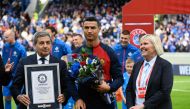Portugal's forward Cristiano Ronaldo (C) is honoured with a certificate of the Guinness World Records for having achieved 200 goals within almost 20 years of his career, prior to the UEFA Euro 2024 group J qualification football match between Iceland and Portugal in Reykjavik on June 20, 2023. Photo by Halldor KOLBEINS / AFP