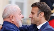 French President Emmanuel Macron (right) embraces Brazil's President Luiz Inacio Lula da Silva as he departs after their meeting at the Elysee Palace, amid the New Global Financial Pact Summit in Paris on June 23, 2023. (Photo by Ludovic Marin / AFP)