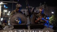 Members of Wagner group looks from a military vehicle with the sign read as 