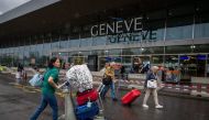 Travellers arrives at Geneva's international airport during strikes on June 30, 2023. Flights at Geneva's international airport will be grounded for four hours due to a workers' strike, affecting thousands of passengers at the start of summer travel season. (Photo by Fabrice COFFRINI / AFP)
