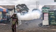 A Kenyan Police Officer walks away from a teargas cloud used to disperse protesters after a public rally against the high cost of living in Nairobi, Kenya on July 7, 2023. (Photo by Luis Tato / AFP)

