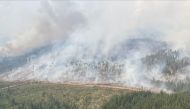 This handout photo provided by the British Columbia Wildfire Service on July 12, 2023, shows the Tintagel wildfire in Tintagel, British Columbia, Canada. (Photo by Handout / BC Wildfire Service / AFP)

