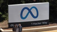 In an aerial view, people gather in front of a sign posted at Meta headquarters on July 07, 2023 in Menlo Park, California. Photo by JUSTIN SULLIVAN / GETTY IMAGES NORTH AMERICA / Getty Images via AFP
