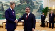 US Climate Envoy John Kerry (L) and China's Premier Li Qiang shake hands before a meeting at the Great Hall of the People in Beijing on July 18, 2023. (Photo by Florence Lo / Pool / AFP)