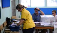 A postman brings postal vote at a polling station in Badalona, during Spain's general election, on July 23, 2023. (Photo by Josep Lago / AFP)