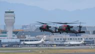 Taiwanese soldiers get out from US made Black Hawk helicopters during the military Han Guang drill at the Taoyuan International Airport on July 26, 2023. (Photo by Sam Yeh / AFP)