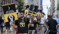 Members of the Writers Guild of America and the Screen Actors Guild walk a picket line outside of Netflix and Warner Bros. Discovery in New York City on August 2, 2023. Photo by ANGELA WEISS / AFP