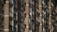 Air conditioners are seen on the facade of a residential building in Malaga, southern Spain, on July 28, 2023. (Photo by JORGE GUERRERO / AFP)