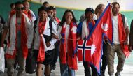 Norwegian climber Kristin Harila (C) and Nepali guide Tenjin Sherpa (C, right) arrive at the Tribhuvan International airport in Kathmandu on August 5, 2023. (Photo by Prakash Mathema / AFP)