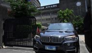 A Chinese diplomatic vehicle leaves the Philippine Department of Foreign Affairs in Manila on August 7, 2023. (Photo by JAM STA ROSA / AFP)