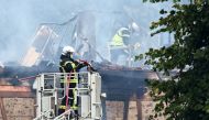 Firefighters work to extinguish a fire which erupted at a home for disabled people in Wintzenheim near Colmar, eastern France, on August 9, 2023. Photo by Sebastien BOZON / AFP