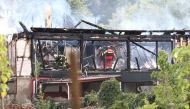 Firefighters inspect a burnt building after a fire erupted at a holiday home for disabled people in Wintzenheim, eastern France, on August 9, 2023. Photo by Sebastien BOZON / AFP