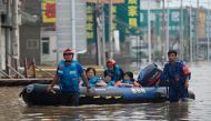 Rescue team personnel wade in a flooded road as they evacuate residents following heavy rains in Zhuozhou, in northern China痴 Hebei province on August 2, 2023. Photo by Jade Gao / AFP
