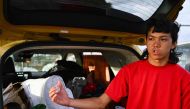 Ekolu Brayden Hoapili speaks about his experience fleeing Lahaina. (Photo by Patrick T. Fallon / AFP)