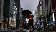 Pedestrians walk with their umbrellas in the rain in Ginza district of Tokyo on August 13, 2023, as Typhoon Lan heads for Japan's main island Honshu. Photo by Philip FONG / AFP