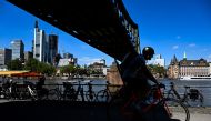 A man ride bicycle along the Main river embankment during a sunny day in Frankfurt am Main, western Germany, on August 10, 2023. Photo by Kirill KUDRYAVTSEV / AFP