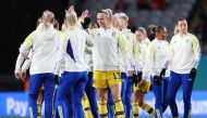 Sweden's defender #13 Amanda Ilestedt (C) high-fives a teammate during warm-ups before the start of the Australia and New Zealand 2023 Women's World Cup semi-final football match between Spain and Sweden at Eden Park in Auckland on August 15, 2023. (Photo by Michael Bradley / AFP)