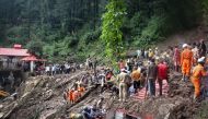 National Disaster Response Force (NDRF) personnel search for victims at the site of a landslide after a temple collapsed due to heavy rains in Shimla on August 14, 2023. Photo by AFP