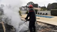A firefighter puts out fires after the blaze that ravaged the commune of Saint-André, Pyrénées-Orientales, France on August 15, 2023. Photo by RAYMOND ROIG / AFP