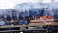 Firefighters try to extinguish a fire which broke out in a train coach parked at the Madurai railway yard, in Madurai on August 26, 2023. (Photo by AFP)