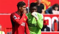 Manchester United's Cameroonian goalkeeper #24 Andre Onana whispers to Manchester United's French defender #19 Raphael Varane during the English Premier League football match between Manchester United and Nottingham Forest at Old Trafford in Manchester, northwest England, on August 26, 2023. Photo by Darren Staples / AFP