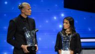 Manchester City's Norwegian striker Erling Haaland (left) and FC Barcelona's Spanish midfielder Aitana Bonmati pose with their season 2022/2023 men's and women's player of the year awards during the UEFA Champions League group stage draw ceremony at The Grimaldi Forum in the Principality of Monaco, on August 31, 2023. (Photo by Nicolas Tucat / AFP)