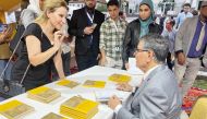 Minister of State and President of Qatar National Library, H E Dr. Hamad bin Abdulaziz Al Kawari signing copies of the German translation of his book Jusoor la Aswar.