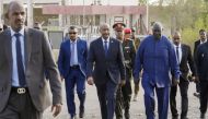 President of Sudan's Transitional Sovereignty Council (TSC) General Abdel Fattah al-Burhan (centre) arrives to board an airplane at Port Sudan airport, heading to South Sudan, on September 4, 2023. (Photo by AFP)