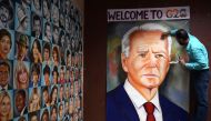 Indian artist Jagjot Singh Rubal gives final touches to an oil painting of US President Joe Biden, at his workshop in Amritsar on September 5, 2023, ahead of the two-day G20 summit in New Delhi. (Photo by Narinder Nanu / AFP)