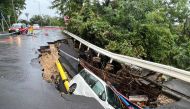  This picture shows a vehicle in a collapsed section of road in Hong Kong on September 8, 2023. (Photo by AFP)
