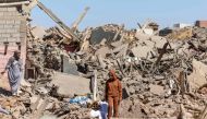 Villagers inspect the rubble of collapsed houses in Tafeghaghte on September 10, 2023. (Photo by Fadel Senna / AFP)