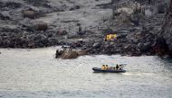 This handout photo taken and released on December 13, 2019 by the New Zealand Defence Force shows soldiers taking part in a mission to retrieve some of the 22 bodies from White Island after the December 9 volcanic eruption, off the coast from Whakatane on New Zealand's North Island. Photo by Handout / New Zealand Defence Force / AFP

