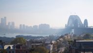 Sydney Harbour Bridge is seen shrouded by smoke in Sydney on September 13, 2023. (Photo by Steve Christo / AFP)
 