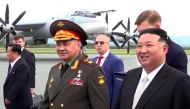 In this video grab taken from footage released on September 16, 2023 by Russian Defence Ministry, North Korea's leader Kim Jong Un (R) and Russia's Defence Minister Sergei Shoigu (L) visit Knevichi aerodrome near Vladivostok, Primorsky region. (Photo by Handout / Russian Defence Ministry / AFP) 