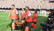 Atletico Madrid's French midfielder #11 Thomas Lemar is evacuated on a stretcher during the Spanish Liga football match between Valencia CF and Club Atletico de Madrid at the Mestalla stadium in Valencia on September 16, 2023. (Photo by JOSE JORDAN / AFP)
