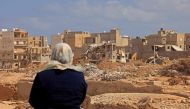 A survivor looks at the rubble of destroyed buildings in Libya's eastern city of Derna on September 18, 2023 following deadly flash floods. (Photo by Karim Sahib / AFP)