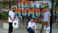 People pose outside the new Apple retail store during a media preview on the eve of its opening in Mumbai on April 17, 2023. (Photo by Punit Paranjpe / AFP)

