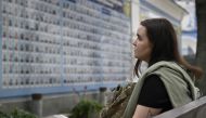 Erika Martyniuk looks at the Memory Wall of Fallen Defenders of Ukraine in Kyiv on September 14, 2023. (Photo by Genya Savilov / AFP)