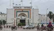 File photo: Motorists drive past the National Assembly in Niamey on August 7, 2023. (Photo by AFP)

