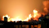A plume of smoke rises above buildings in Gaza City during an Israeli air strike yesterday.