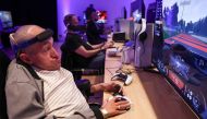 Jeremy Lecerf, also known as Mr Gyzmo, tries out the new Playstation Access controller at a demonstration event in London on October 5, 2023. (Photo by Henry Nicholls / AFP)