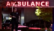 An armed police officer guards the ambulance entrance to the Central Maine Medical Center in Lewiston, Maine early on October 26, 2023. (Photo by Joseph Prezioso / AFP)
 