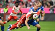 Bayern Munich's English midfielder Harry Kane heads the first goal for Munich against Darmstadt's Austrian defender #14 Christoph Klarer during the German first division Bundesliga football match between FC Bayern Munich and SV Darmstadt 98 in Munich, southern Germany on October 28, 2023. (Photo by Christof Stache / AFP)