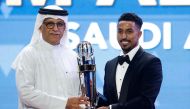 President of the Asian Football Confederation (AFC) Shaikh Salman bin Ibrahim al-Khalifa (L) presents Saudi Arabia's forward Salem al-Dawsari with the AFC Player of the Year award during the AFC Annual Awards Doha 2022 on October 31, 2023. (Photo by KARIM JAAFAR / AFP)
