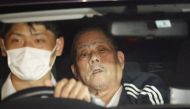 Suspect Tsuneo Suzuki (R), who barricaded himself in a post office, is transferred by a police vehicle in Warabi city, Saitama prefecture on October 31, 2023. Photo by JIJI PRESS / AFP