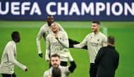 PSG's Kylian Mbappe with Lucas Hernandez (right) and teammates during a training session on the eve of the match against AC Milan, yesterday. AFP