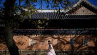 People wear traditional Hanbok dresses as they visit the Gyeongbokgung Palace grounds in Seoul on November 2, 2023. Photo by ANTHONY WALLACE / AFP